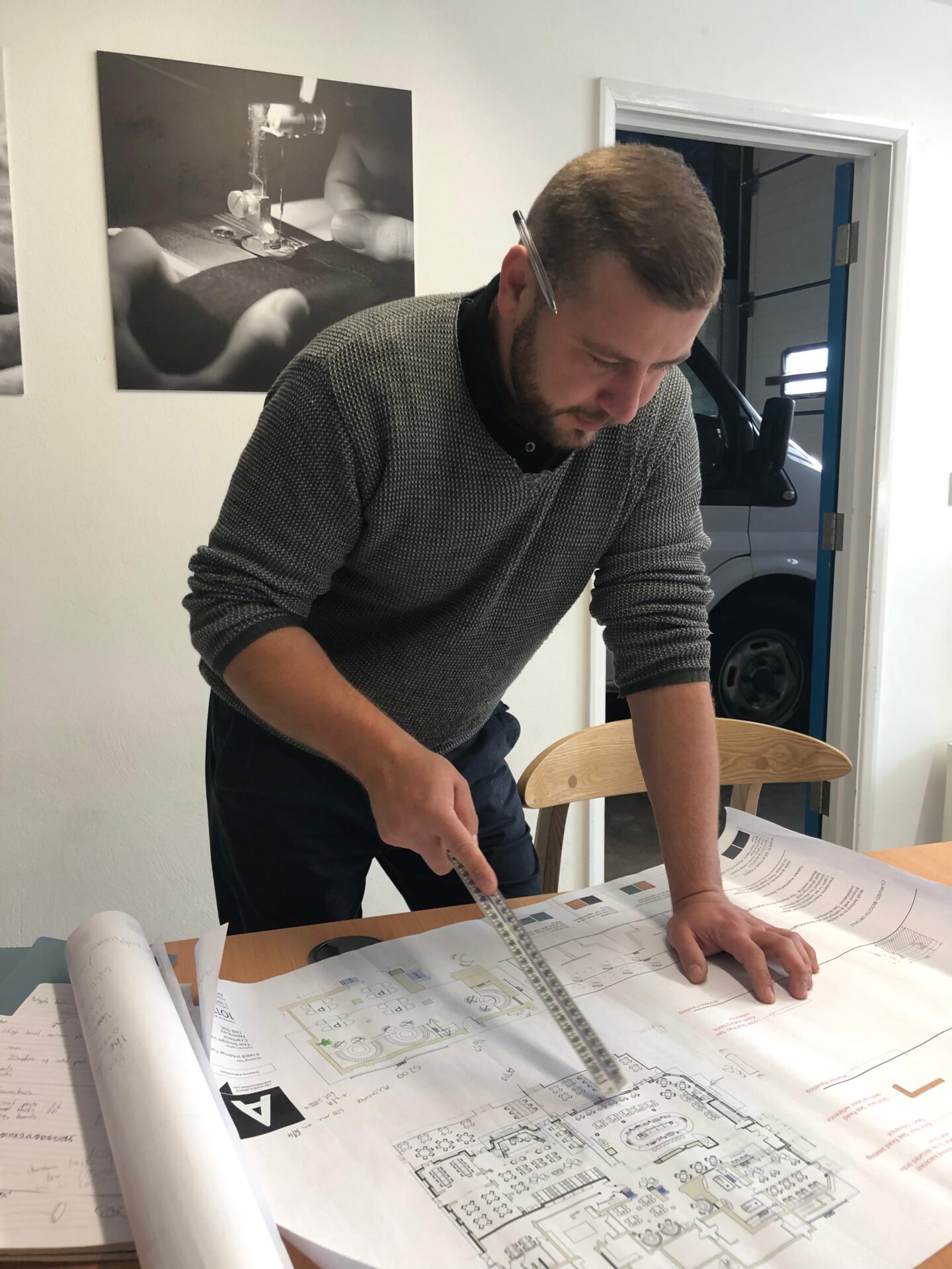 Specialist reviewing technical seating layout drawings