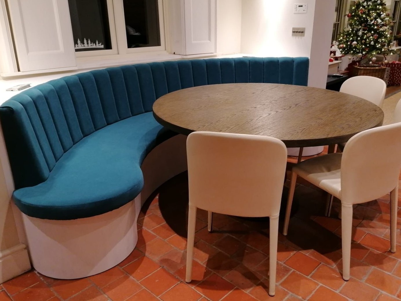 Bespoke upholstered teal fluted curved sofa in a modern living room