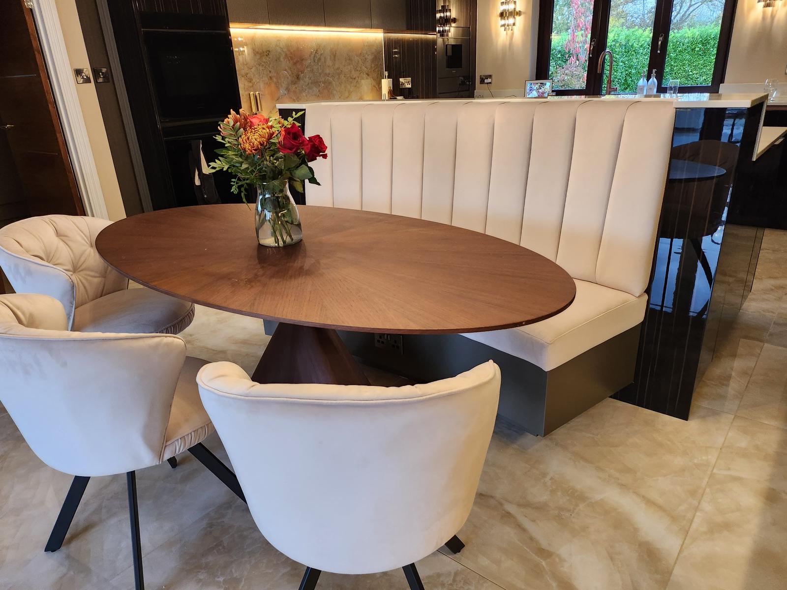Luxury bespoke dining banquette with cream upholstery and walnut table, handcrafted for a modern kitchen in the UK