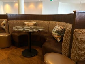 Comfortable curved brown booth seating with patterned backrests in a lounge.